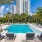 a pool with lounge chairs around it
