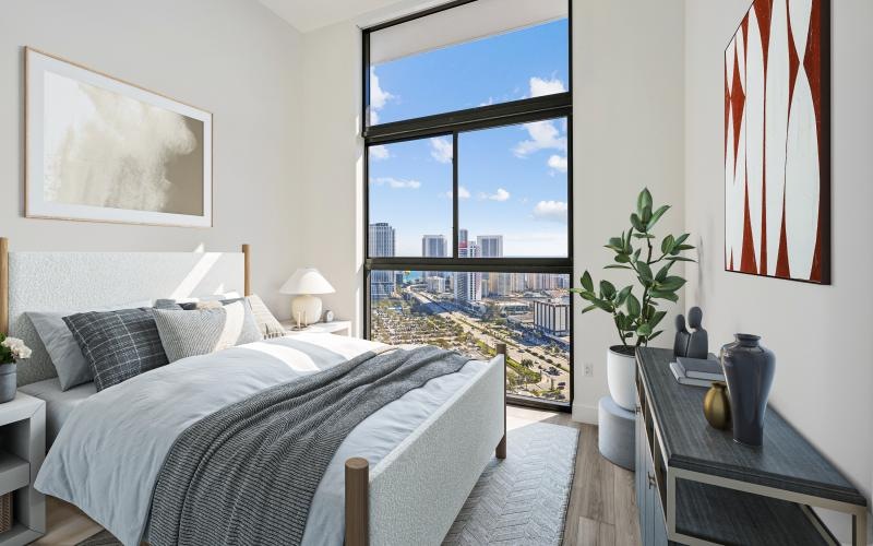 a bedroom with a view of the city