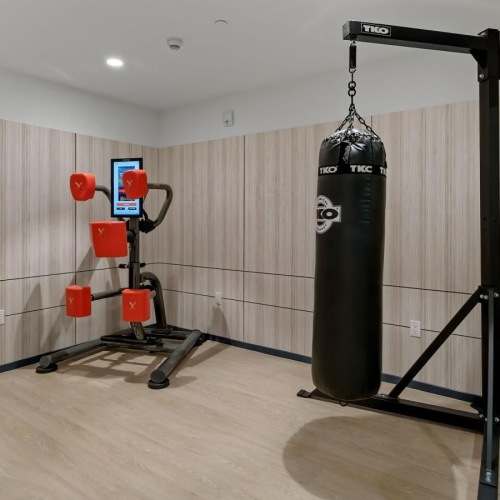 Quick access to state-of-the-art amenities a gym with a black punching bag