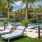 a backyard with a hammock and chairs and trees