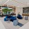 a living room with a blue couch and a large window