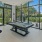 a large room with a large glass door and a table and chairs