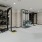 a room with a large black shelf and a large metal rack with objects